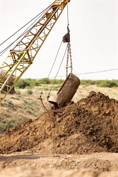 excavators digging with big buckets